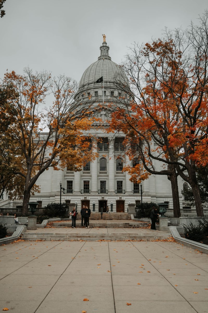 Wisconsin State Capitol in Madison framed by autumn trees
